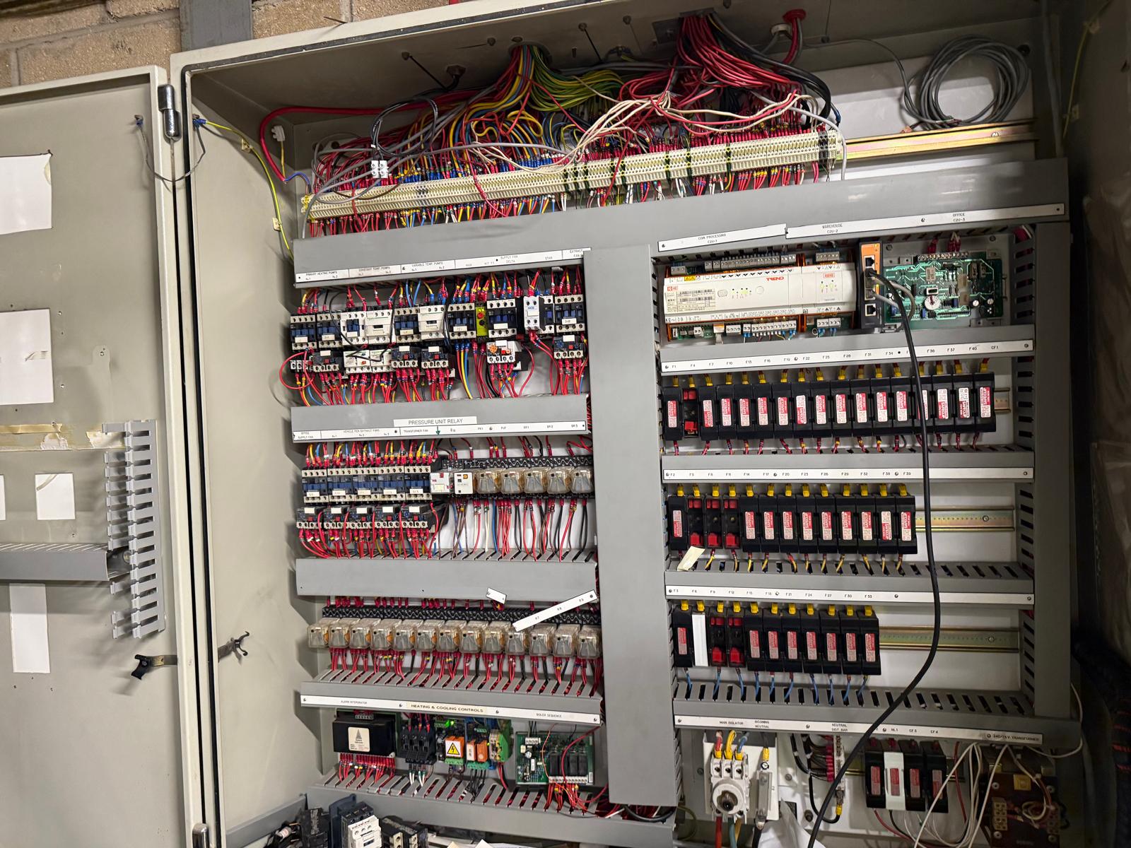 Legacy BMS panel with Trend outstation and fuse banks inspected during a scheduled service visit